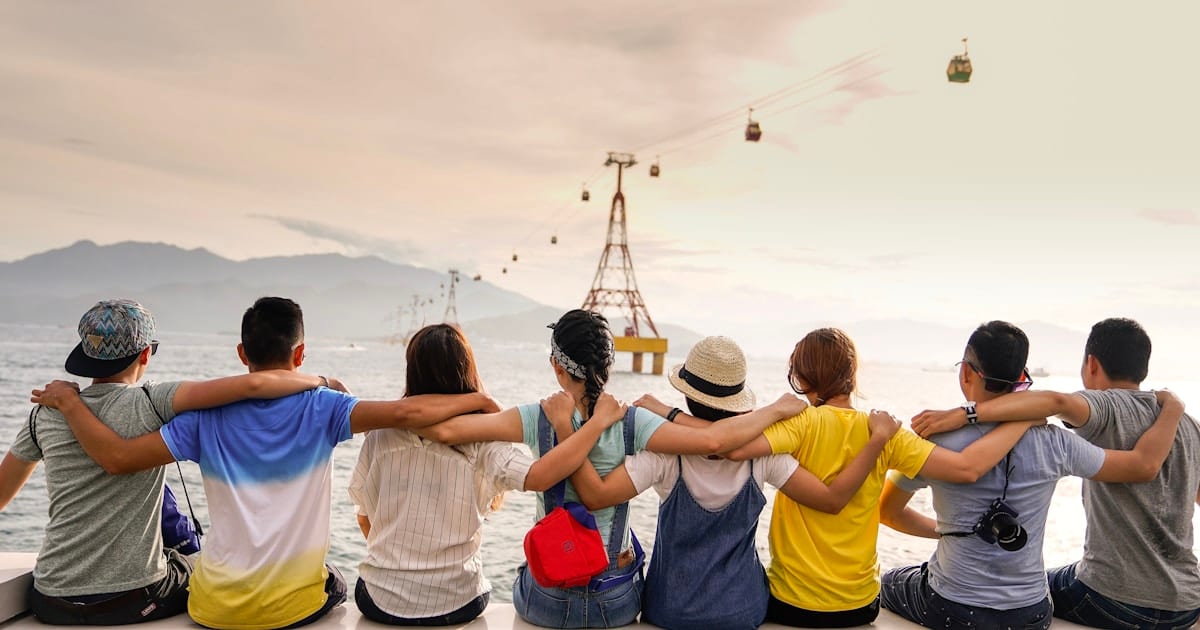 Diverse group of friends with arms around each other