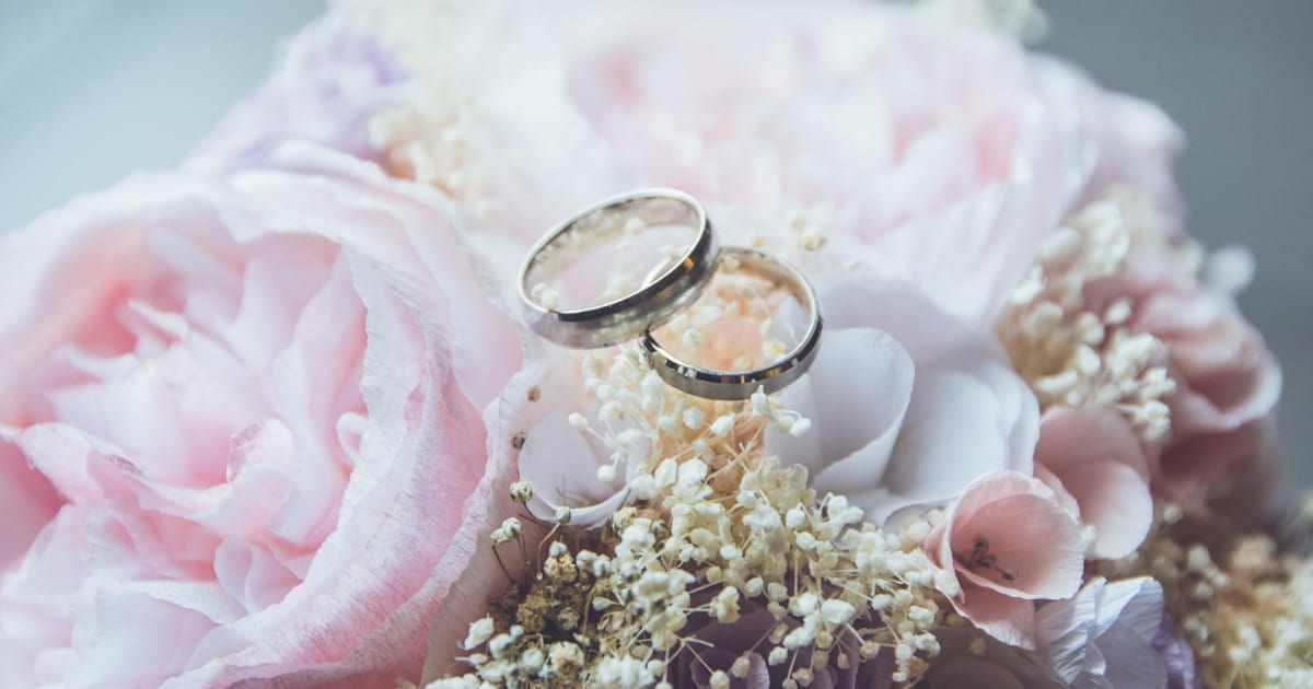 Wedding rings on floral arrangement