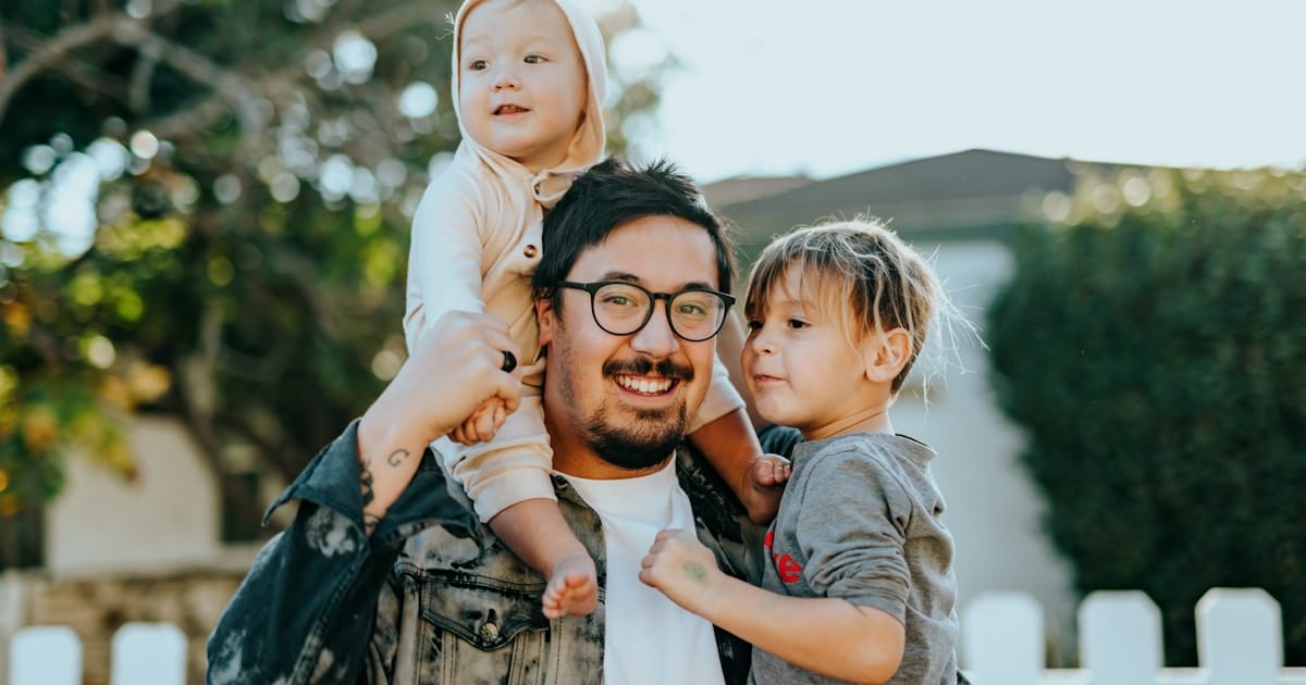Father with two young children outdoors